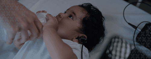Image of a newborn undergoing an otoacoustic emissions test